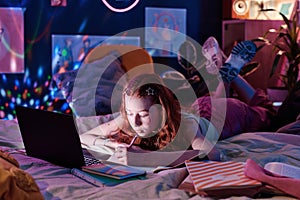 Teen Girl Doing Homework Late In Evening