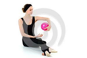 Teen girl doing rhythmic gymnastics with pink ball