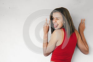 Teen girl doing victory sign winking and sticking out her tongue