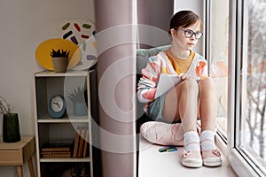 Teen Girl With Down Syndrome By Window