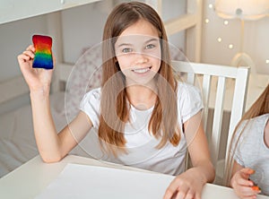 Teen girl drawing rainbow. stay at home. photo