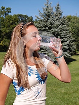 Teen girl drinking water