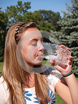 Teen girl drinking water