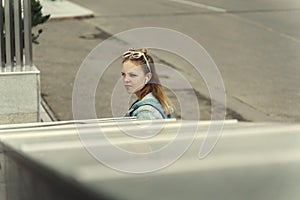 Teen girl with earphone sad outdoor in city