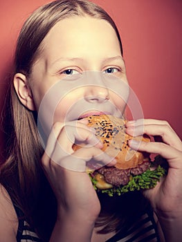 Teen girl eating a burger