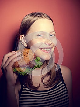 Teen girl eating a burger