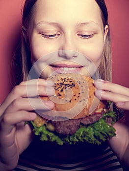 Teen girl eating a burger