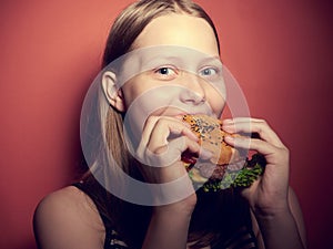 Teen girl eating a burger