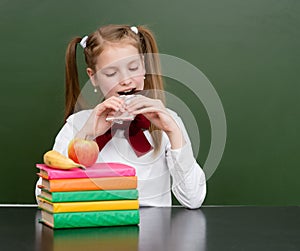 Teen girl eating chocolate at lunchtime photo