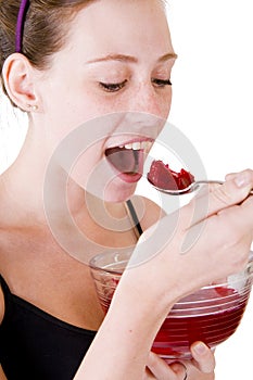 A teen girl eating jello photo