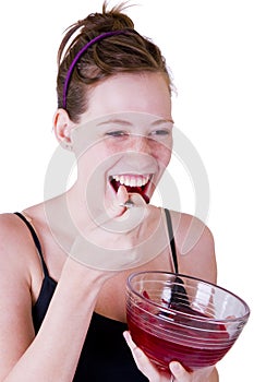 A teen girl eating jello