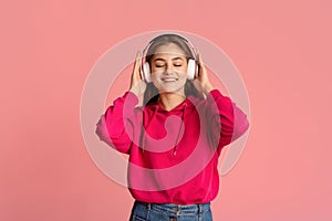 Teen girl enjoying favorite music in headphones