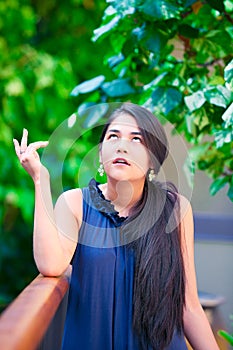 Teen girl with exasperated expression, looking up eyes rolled photo