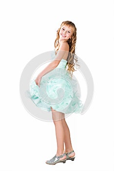 Teen girl in fancy gown dancing isolated