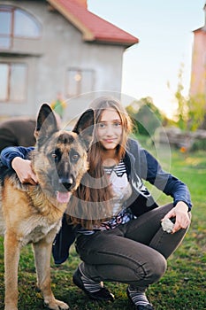 The teen girl finds solace in communicating with her friend a dog by a German shepherd