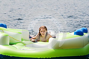 Teen girl floating in a lake