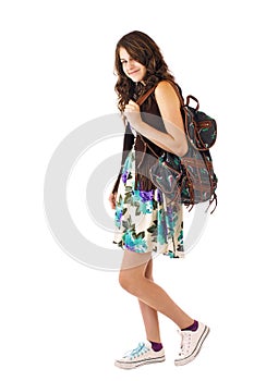 Teen girl in flowered dress and backpack