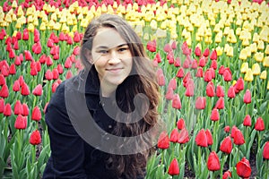 Teen Girl in Front of Red and Yellow Tulips