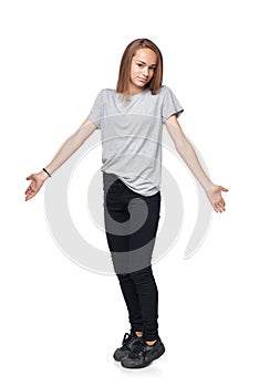 Teen girl in full length shrugging her shoulders