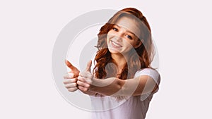 Teen Girl Gesturing Thumbs-Up With Both Hands Over White Background