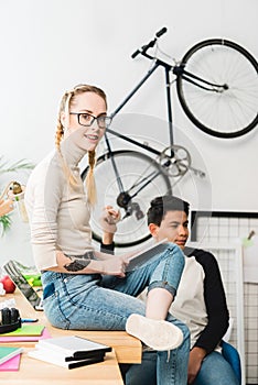 teen girl with glasses and braces sitting on table