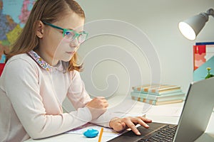 Teen girl in glasses sudy at home at online classroom meeting during pandemic distance homeschooling