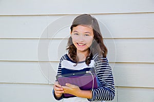 Teen girl happy holding tablet pc and earings photo