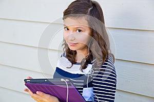 Teen girl happy holding tablet pc and earings photo