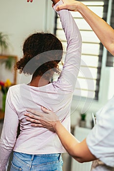 Teen Girl having chiropractic back adjustment. Osteopathy, Physiotherapy, Kinesiology. Bad posture correction