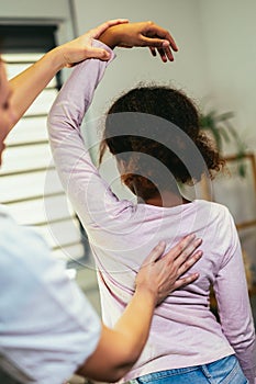 Teen Girl having chiropractic back adjustment. Osteopathy, Physiotherapy, Kinesiology. Bad posture correction