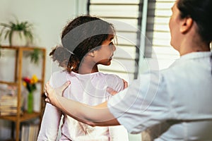 Teen Girl having chiropractic back adjustment. Osteopathy, Physiotherapy, Kinesiology. Bad posture correction