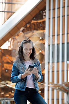 Teen girl having a mobile phone talk in a large metropolis