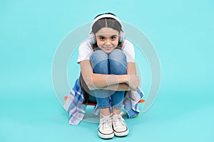 Teen girl in headphones listen to music. Wireless headset device accessory. Child enjoys the music in earphones on