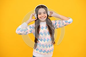 Teen girl in headphones listen to music. Wireless headset device accessory. Child enjoys the music in earphones on