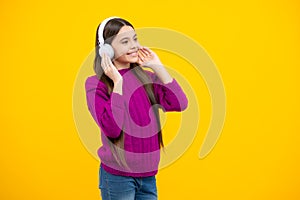 Teen girl in headphones listen to music. Wireless headset device accessory. Child enjoys the music in earphones on