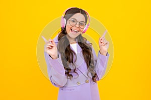 Teen girl in headphones listen to music. Wireless headset device accessory. Child enjoys the music in earphones on