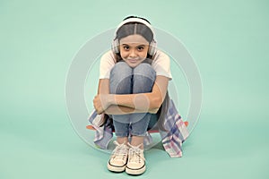 Teen girl in headphones listen to music. Wireless headset device accessory. Child enjoys the music in earphones on