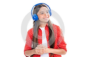 Teen girl in headphones listen to music. Wireless headset device accessory. Child enjoys the music in earphones on white