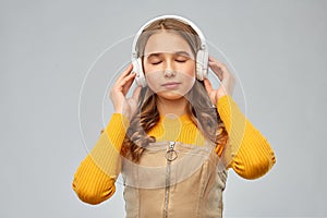 Teen girl in headphones listening relaxing music