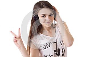 Teen girl with headphones showing victory sign
