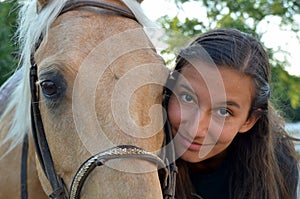 A teen girl with her horse