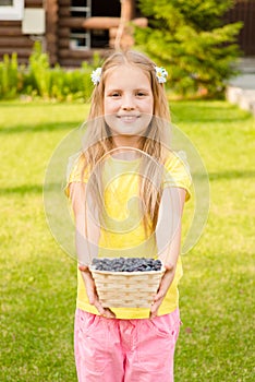 Teen girl holding basket with berry