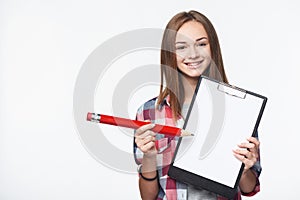 Teen girl holding big pencil and blank paper sheet on tablet