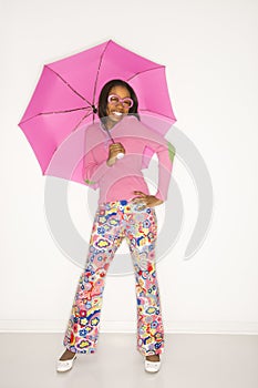 Teen girl holding umbrella.