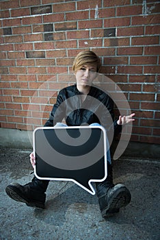 Teen girl holds black sign