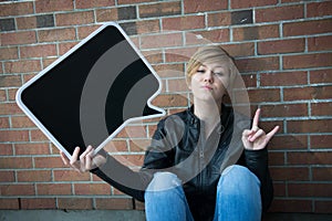 Teen girl holds black sign