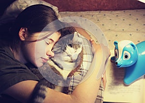 Teen girl hug cuddle cat in bed