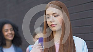 Teen girl ignoring mockery of classmates, resisting bullying, inner strengths