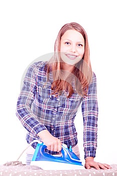 Teen girl ironing clothes