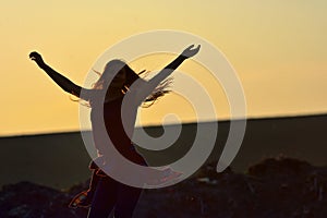 Teen girl jump against beautiful sunset